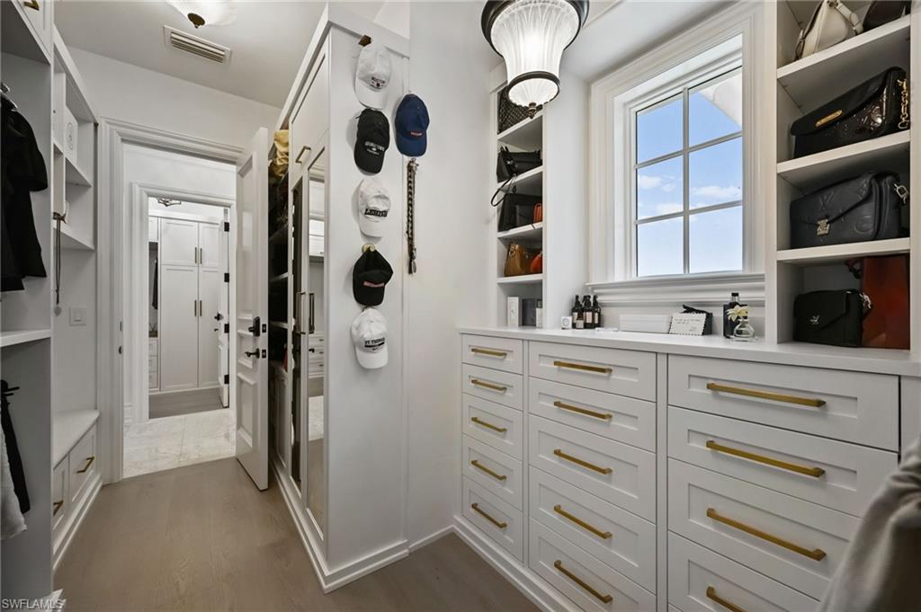 Walk in closet featuring dark wood finished floors