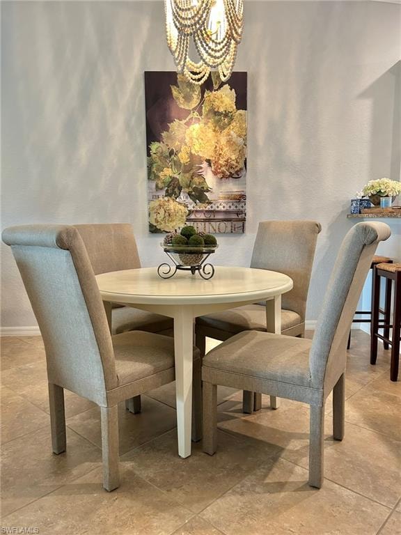 Dining space with hanging lights and baseboards