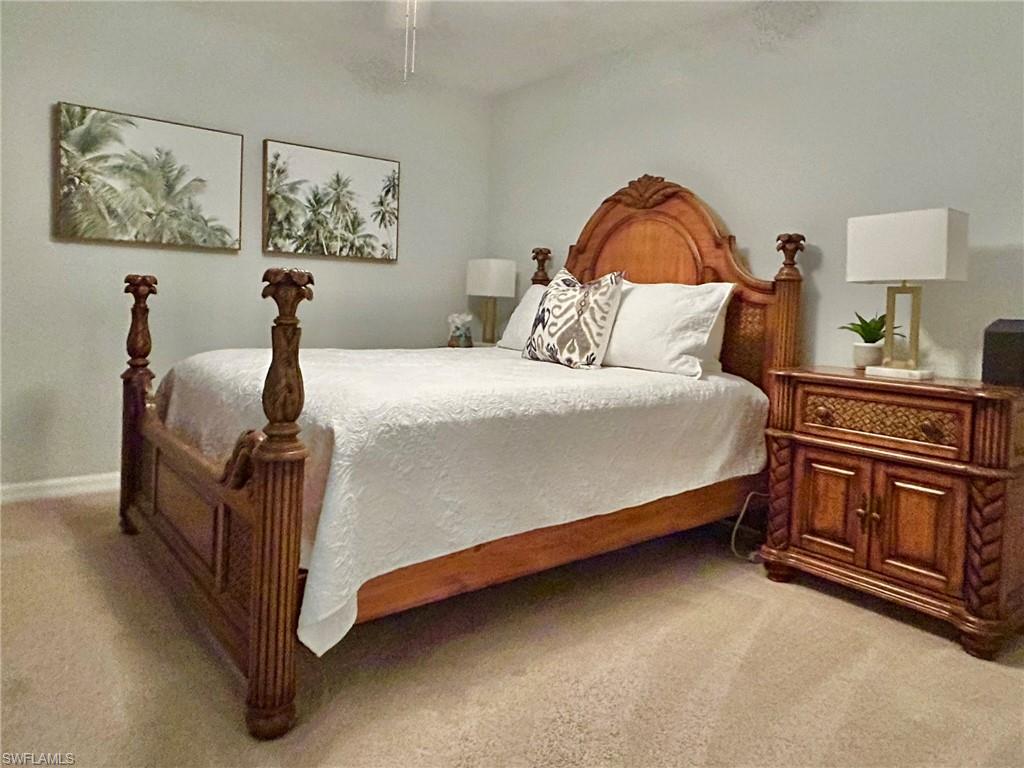 Bedroom featuring light carpet