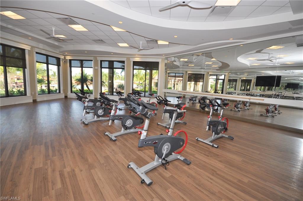 Workout area with ceiling fan and a paneled ceiling