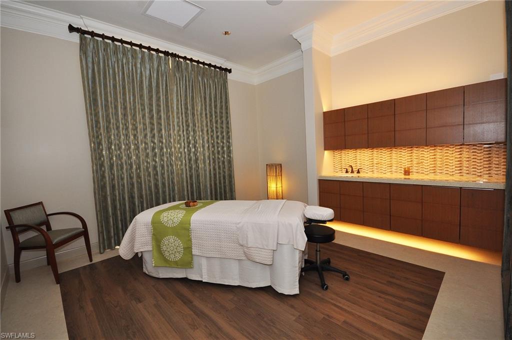 Bedroom with ornamental molding and dark wood finished floors