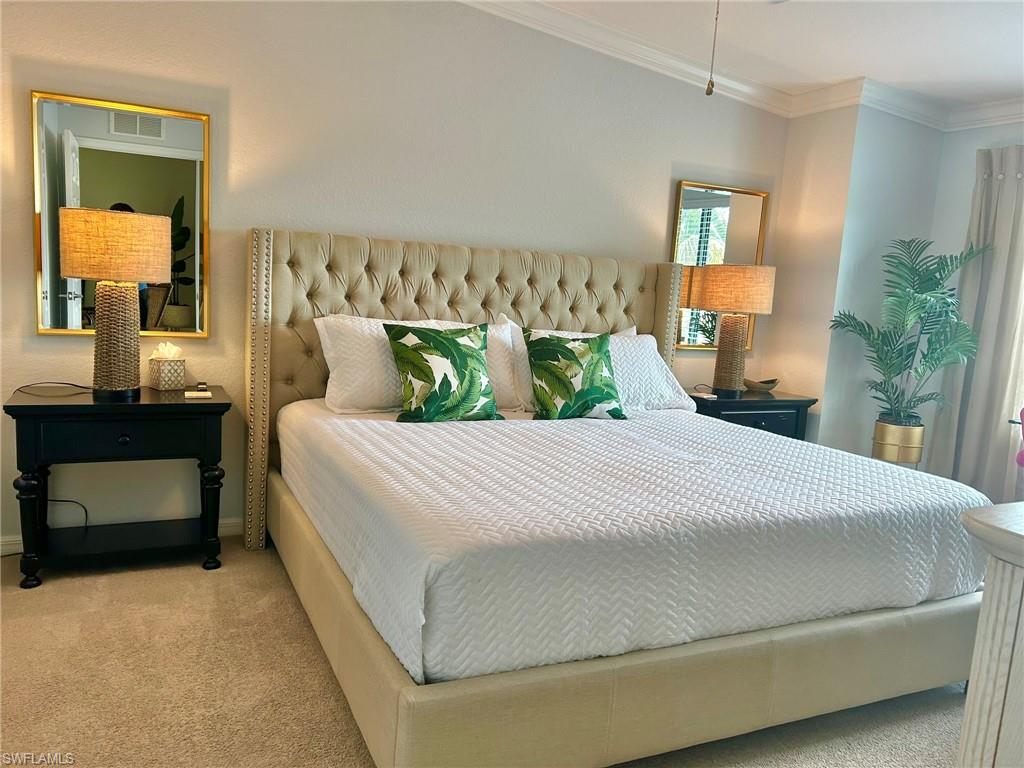 Bedroom featuring carpet floors and crown molding