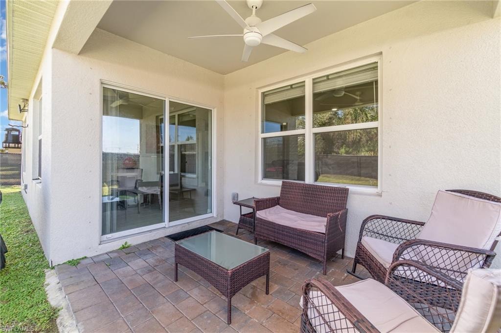 View of patio featuring ceiling fan and an outdoor hangout area