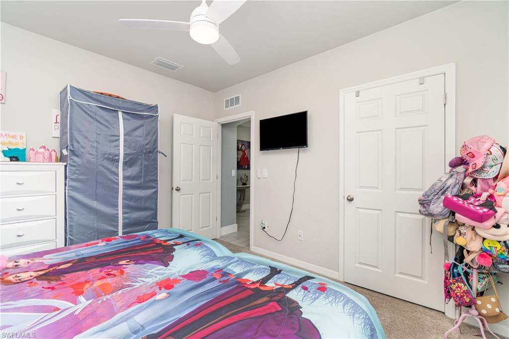 Bedroom featuring light colored carpet and ceiling fan