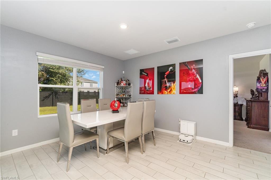 Dining area with baseboards and wood finish floors