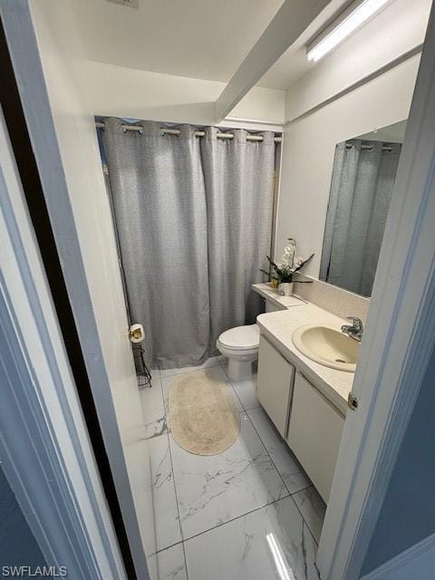 Bathroom with curtained shower, vanity, and light marble finish flooring