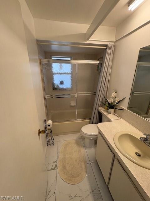 Full bath with enclosed tub / shower combo, vanity, and light marble finish flooring