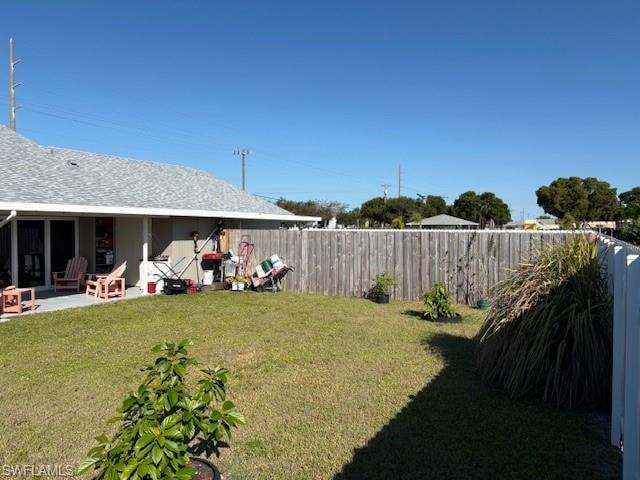 Fenced backyard featuring a patio