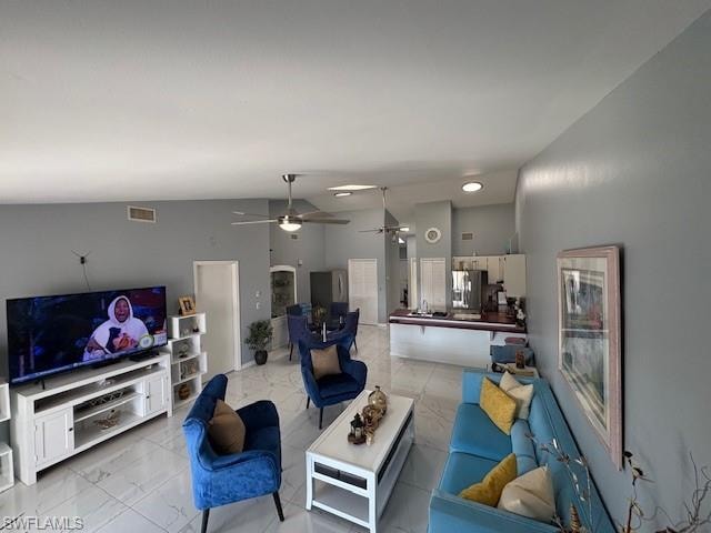 Living room with arched walkways and ceiling fan