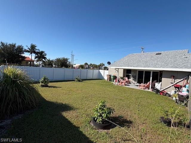 Fenced backyard with a patio area