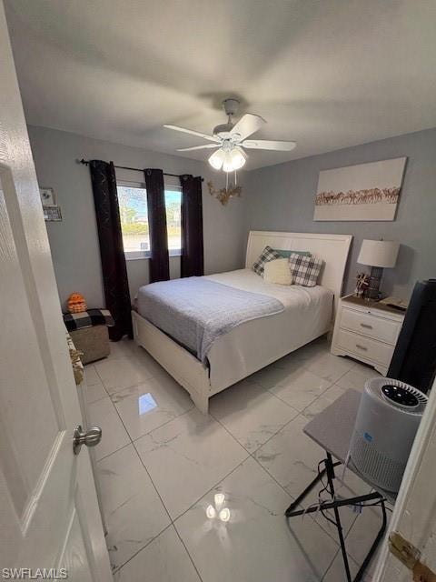 Bedroom featuring light marble finish flooring and a ceiling fan