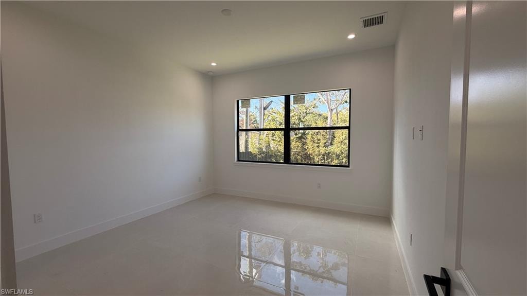 Unfurnished room with baseboards and recessed lighting