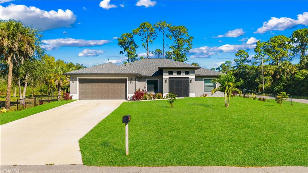 Prairie-style home with stucco siding, concrete driveway, an attached garage, and a shingled roof