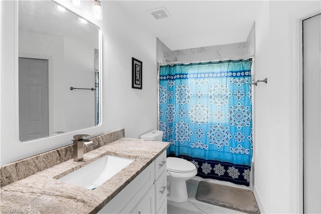 Bathroom featuring vanity and light tile patterned floors