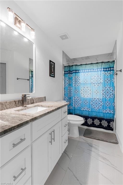 Bathroom with vanity and light marble finish floors
