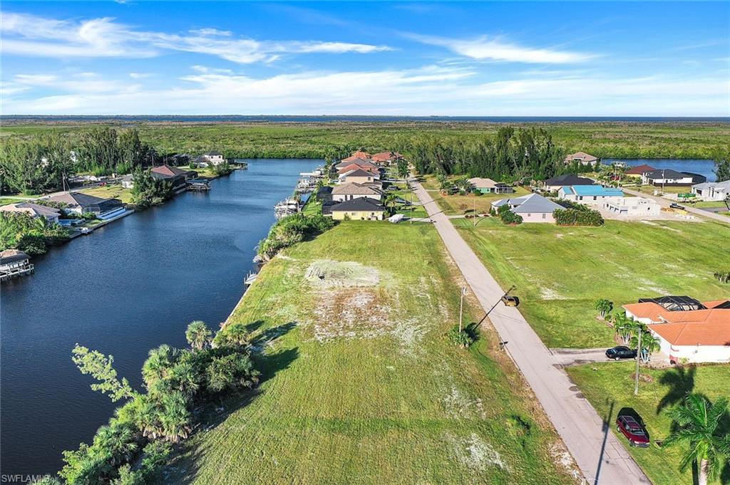 Aerial perspective of suburban area featuring a large body of water