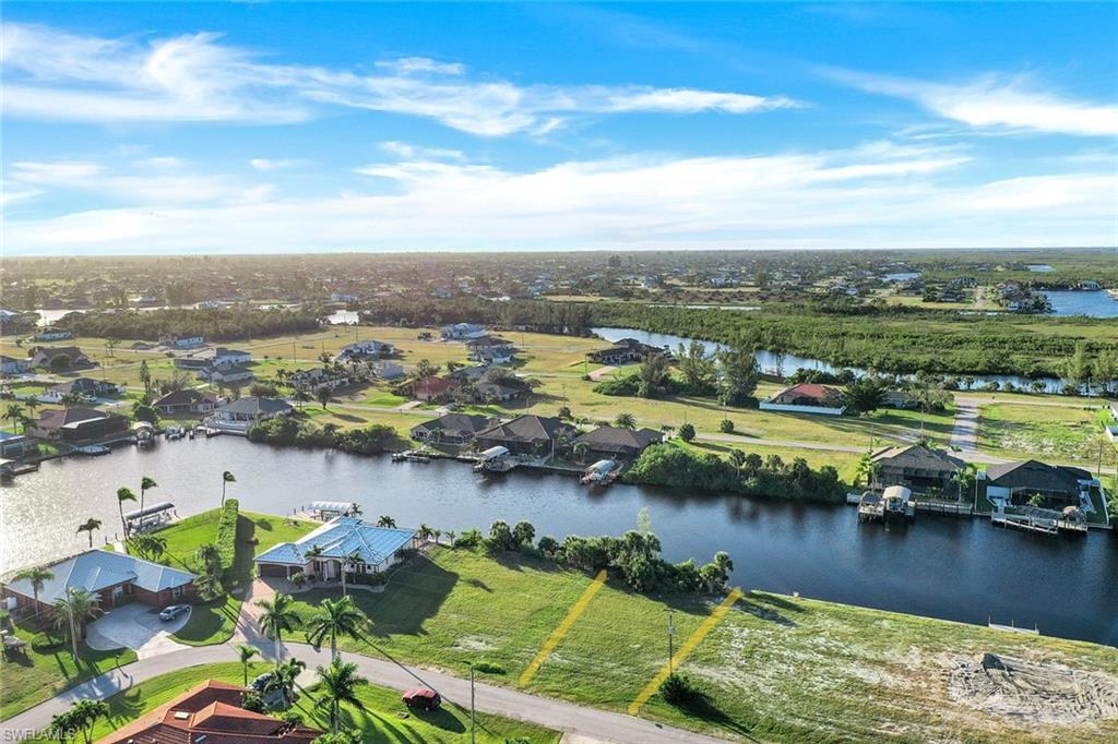 Aerial perspective of suburban area featuring a large body of water