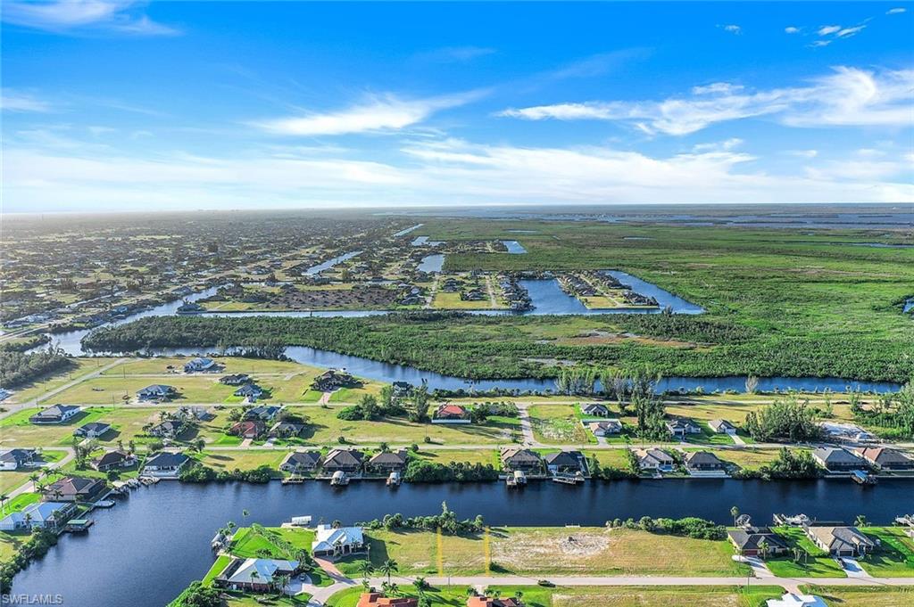 Aerial view of residential area featuring a large body of water