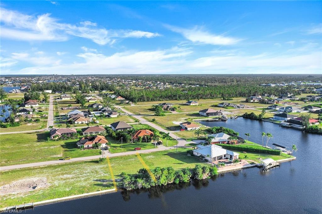 Aerial perspective of suburban area featuring a large body of water