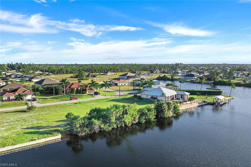 Aerial perspective of suburban area featuring a large body of water
