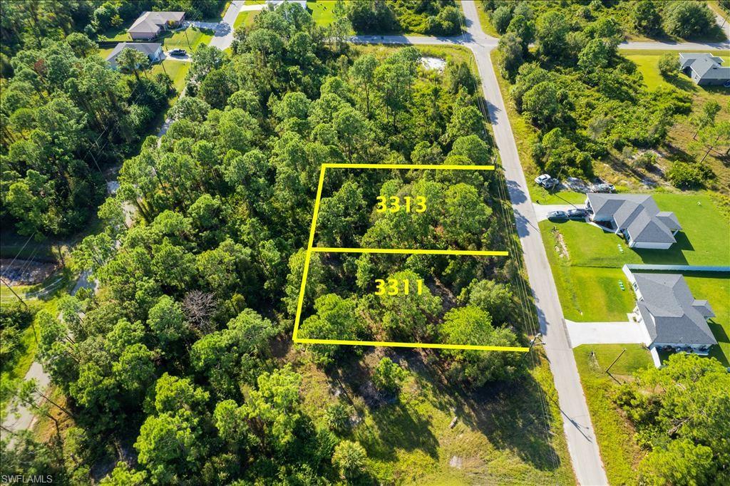 Aerial overview of property's location with a forest and property parcel outlined