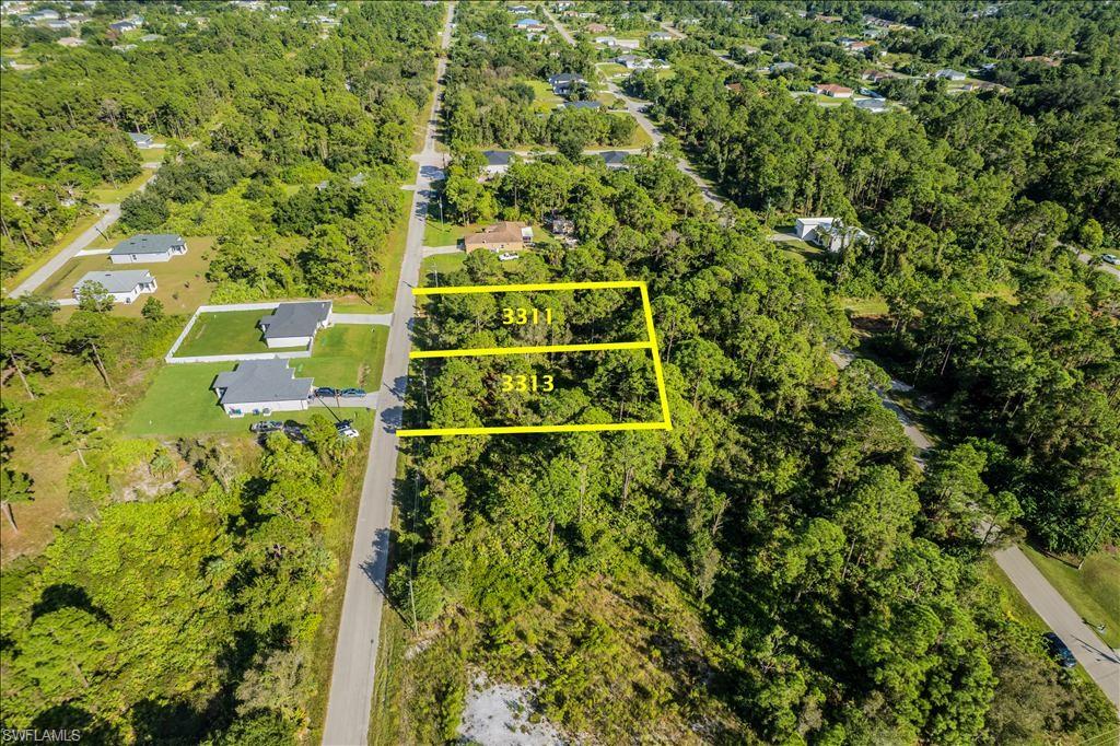 Aerial view of property and surrounding area with property parcel outlined