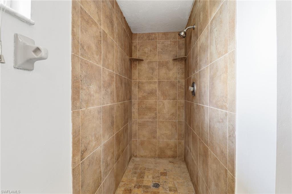 Full bath with a tile shower