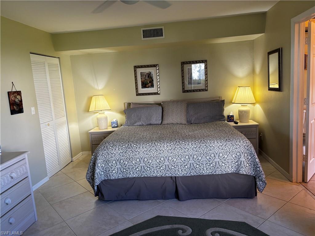 Tiled bedroom featuring a closet and a ceiling fan