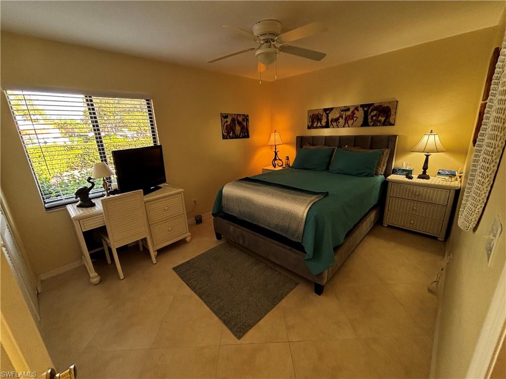 Bedroom with ceiling fan and baseboards