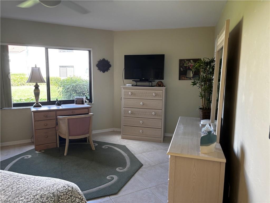 Bedroom with light tile patterned floors and ceiling fan