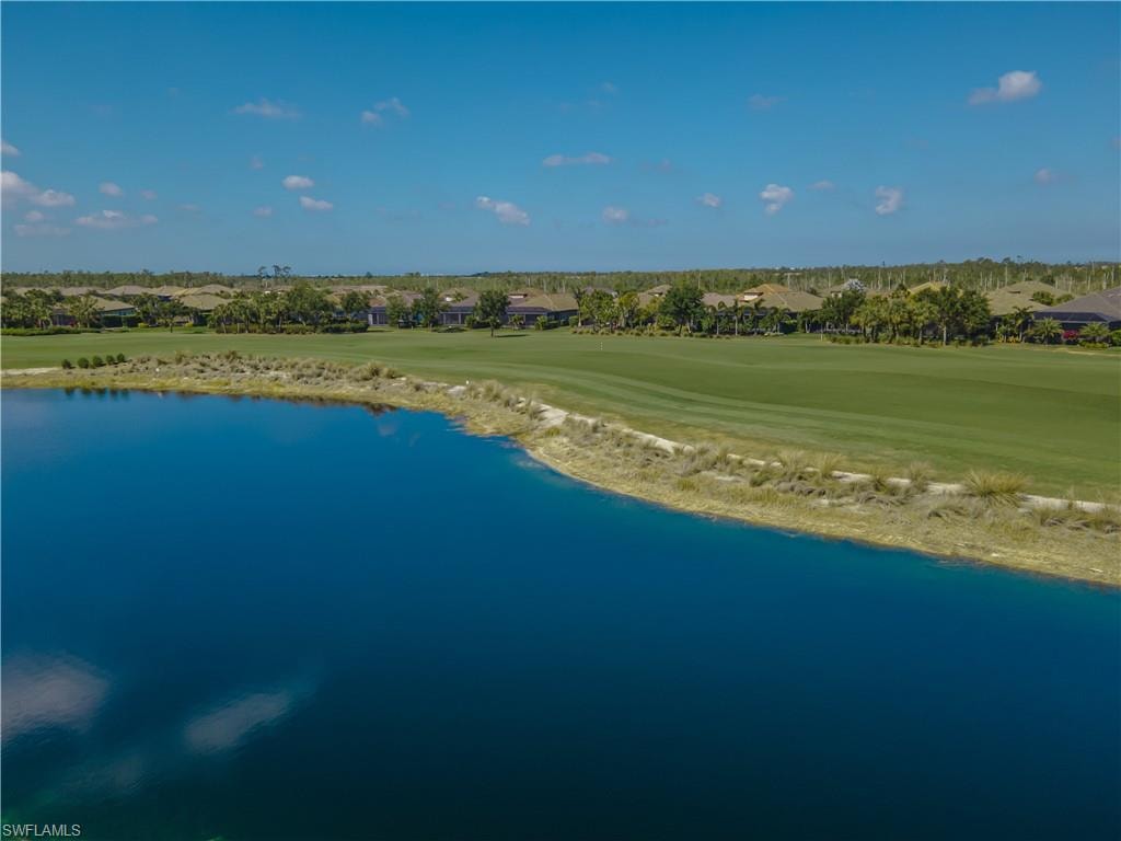 Aerial perspective of suburban area with a golf club and a nearby body of water