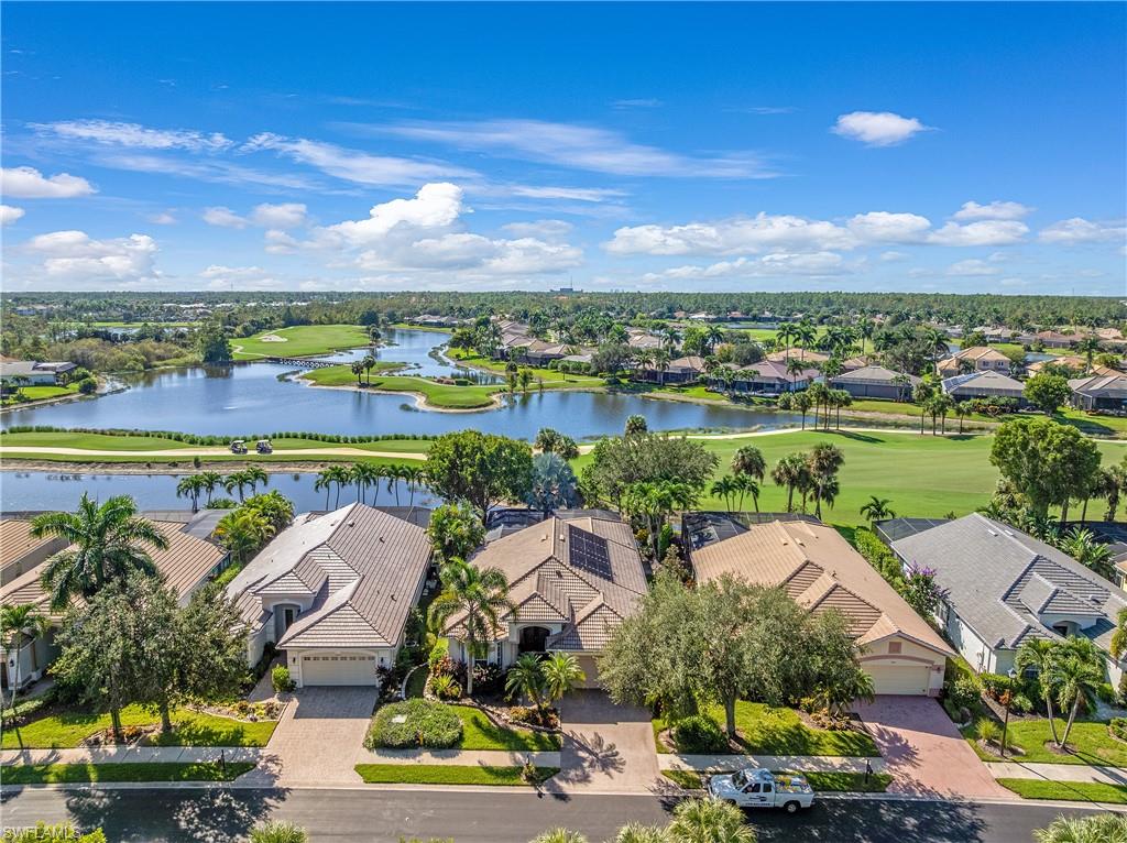 Aerial perspective of suburban area with a golf club and a large body of water