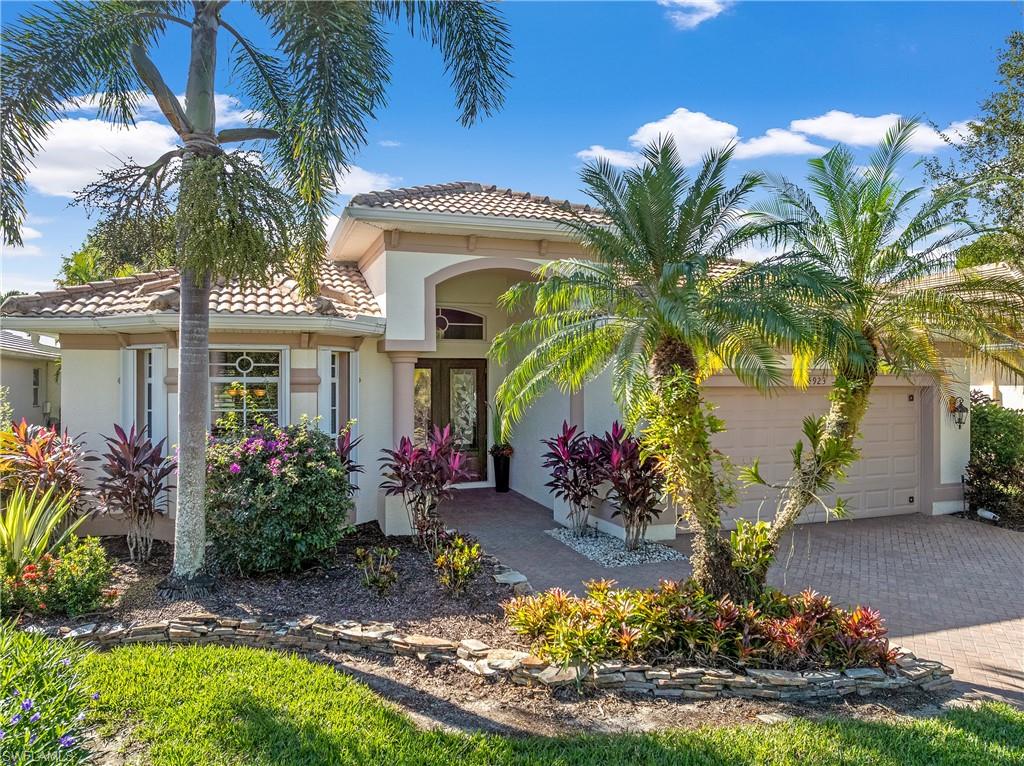 Mediterranean / spanish-style house featuring stucco siding, decorative driveway, a tile roof, and an attached garage