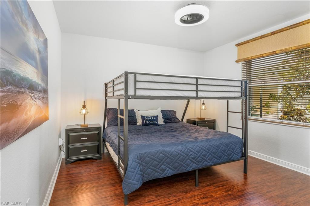 Bedroom with wood finished floors and baseboards