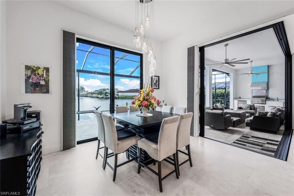 Dining space featuring a water view and a ceiling fan