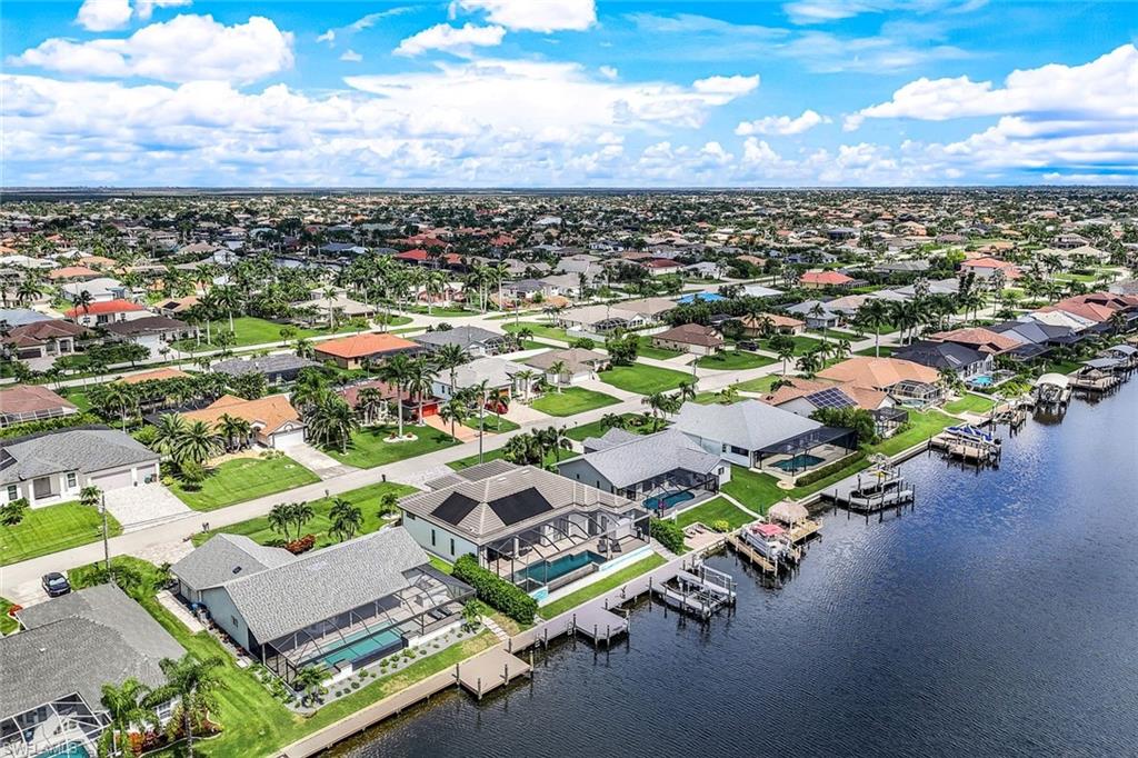 Aerial view of residential area featuring a nearby body of water