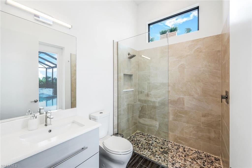 Bathroom featuring a walk in shower and vanity