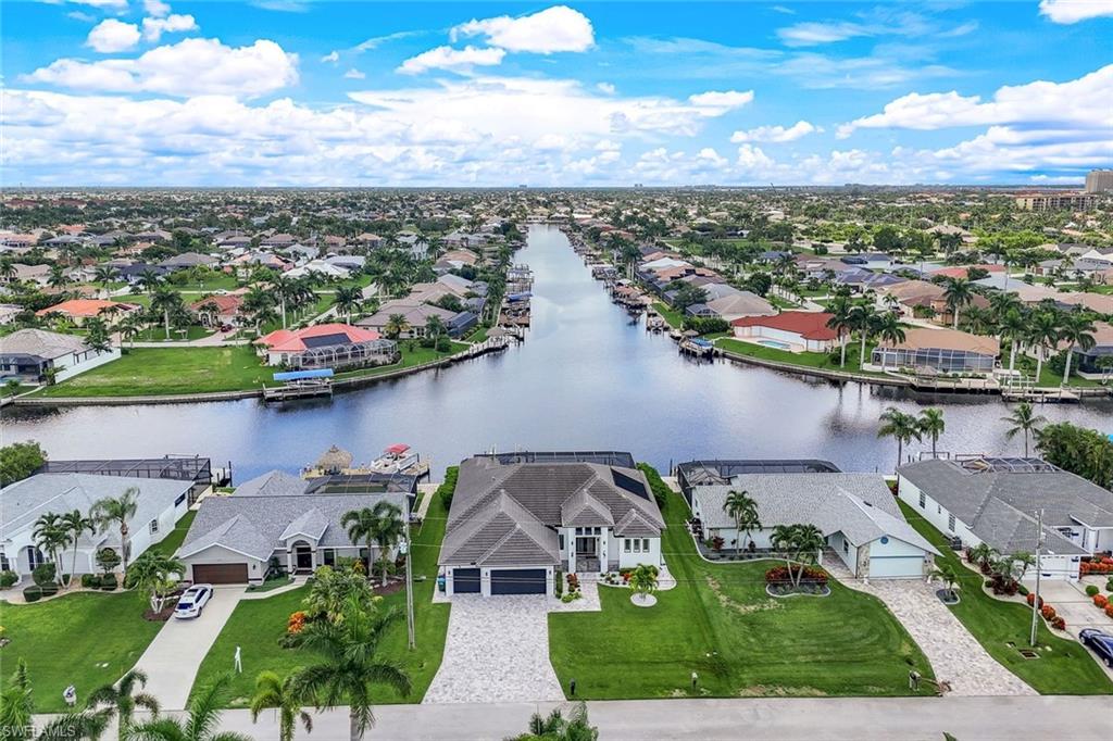 Aerial perspective of suburban area featuring a large body of water