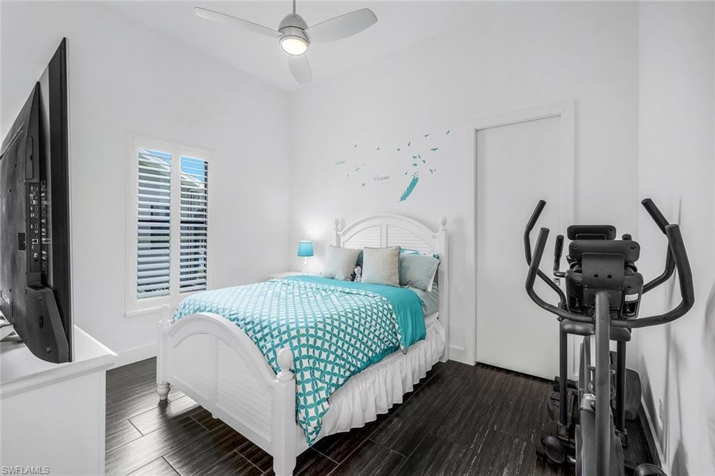 Bedroom featuring wood tiled floors and a ceiling fan