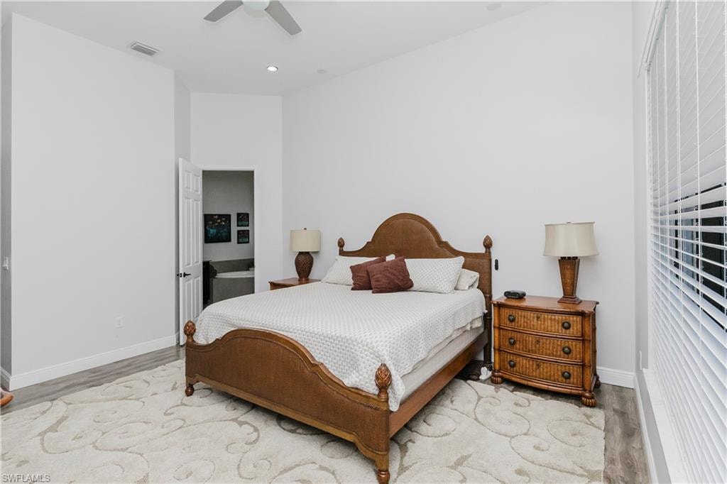 Bedroom with a ceiling fan, light wood-style flooring, and recessed lighting