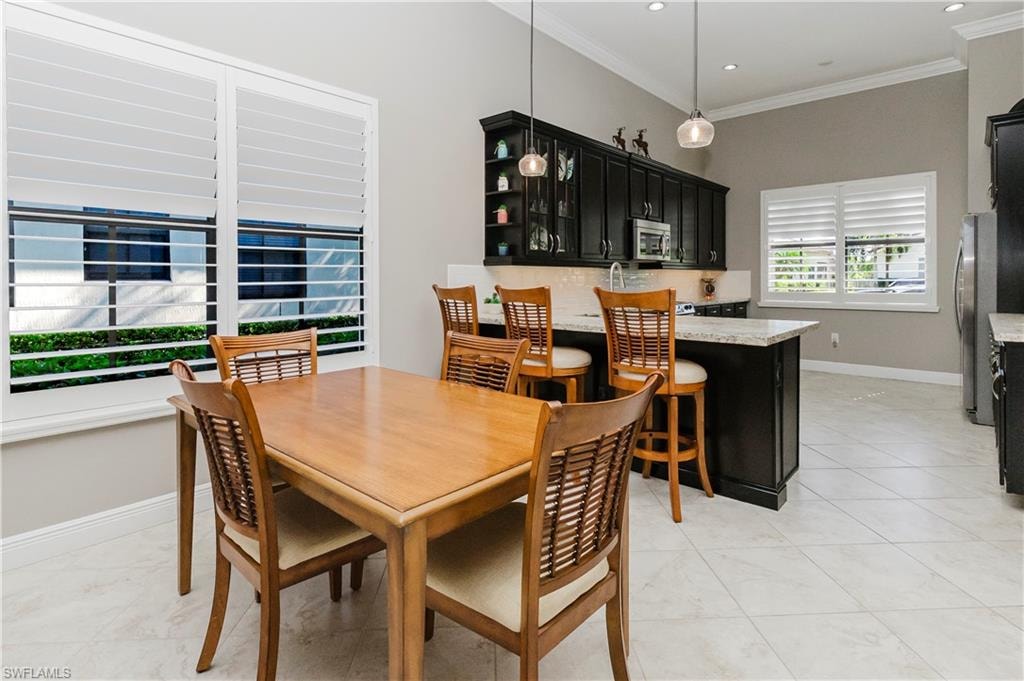 Dining room featuring ornamental molding, light tile patterned flooring, and recessed lighting