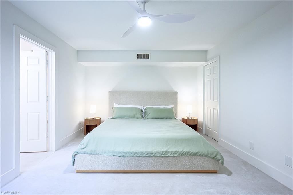 King size Bedroom  desk with a ceiling fan
