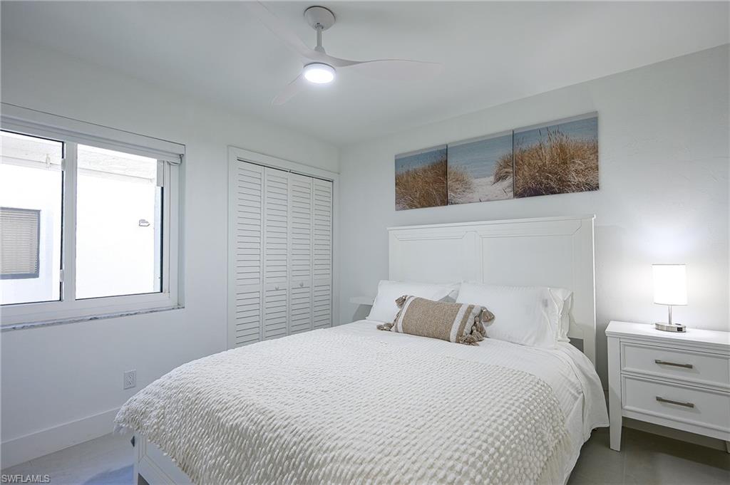 2nd bedroom queen bedroom with a closet and a ceiling fan