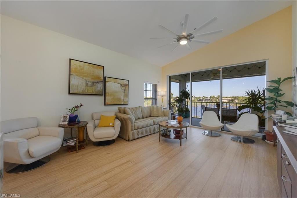 Living area with vaulted ceiling, light wood-type flooring, and ceiling fan