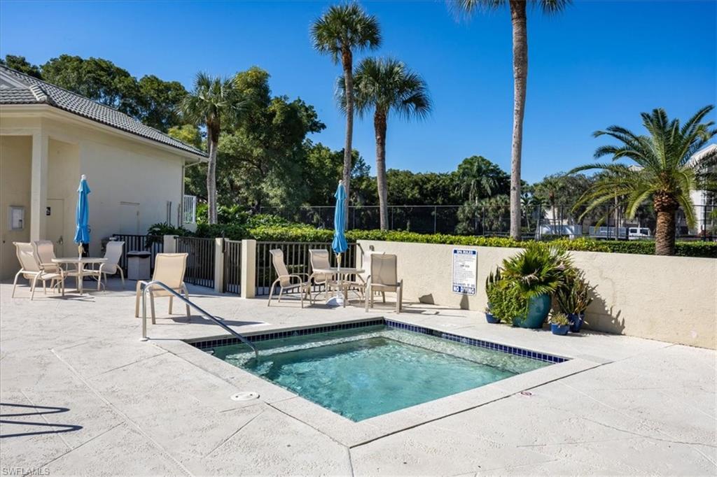 View of swimming pool with a patio area, a hot tub, and a pool
