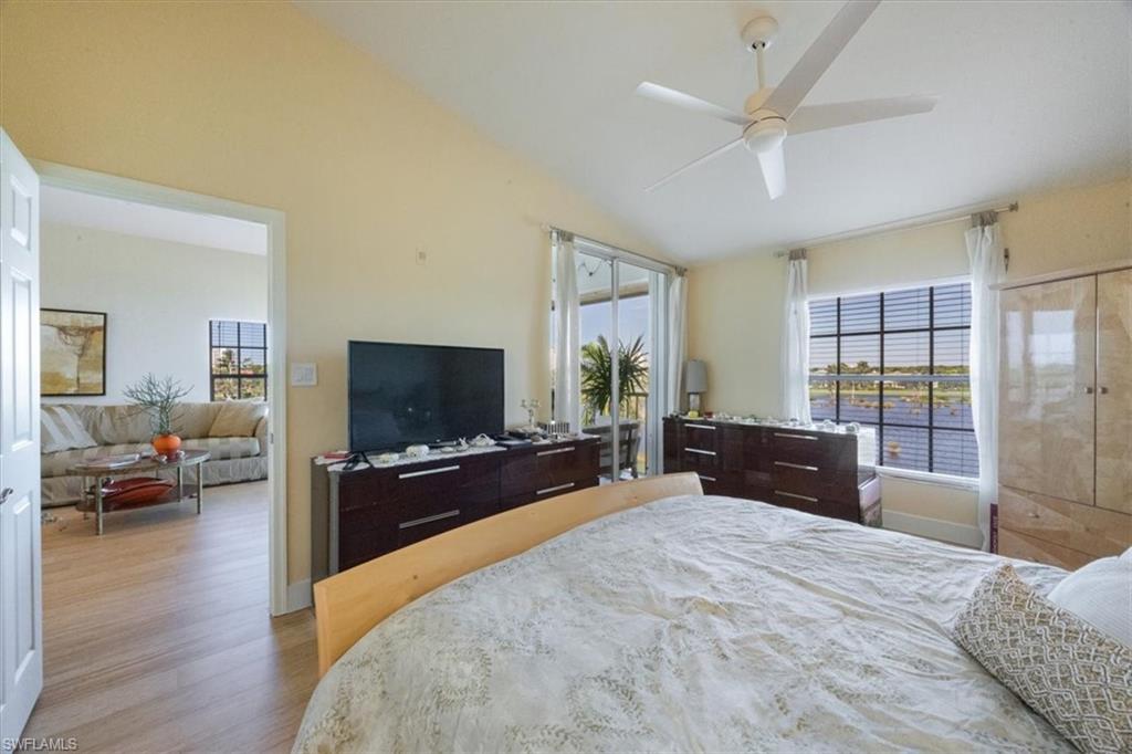 Bedroom featuring vaulted ceiling, wood finished floors, and ceiling fan