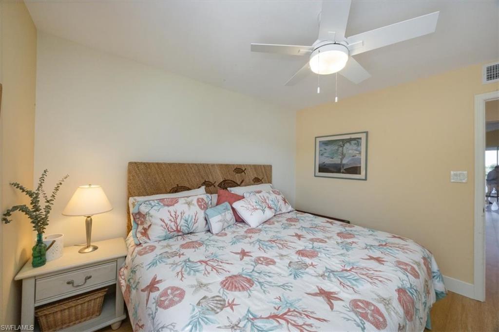 Bedroom with ceiling fan and wood finished floors
