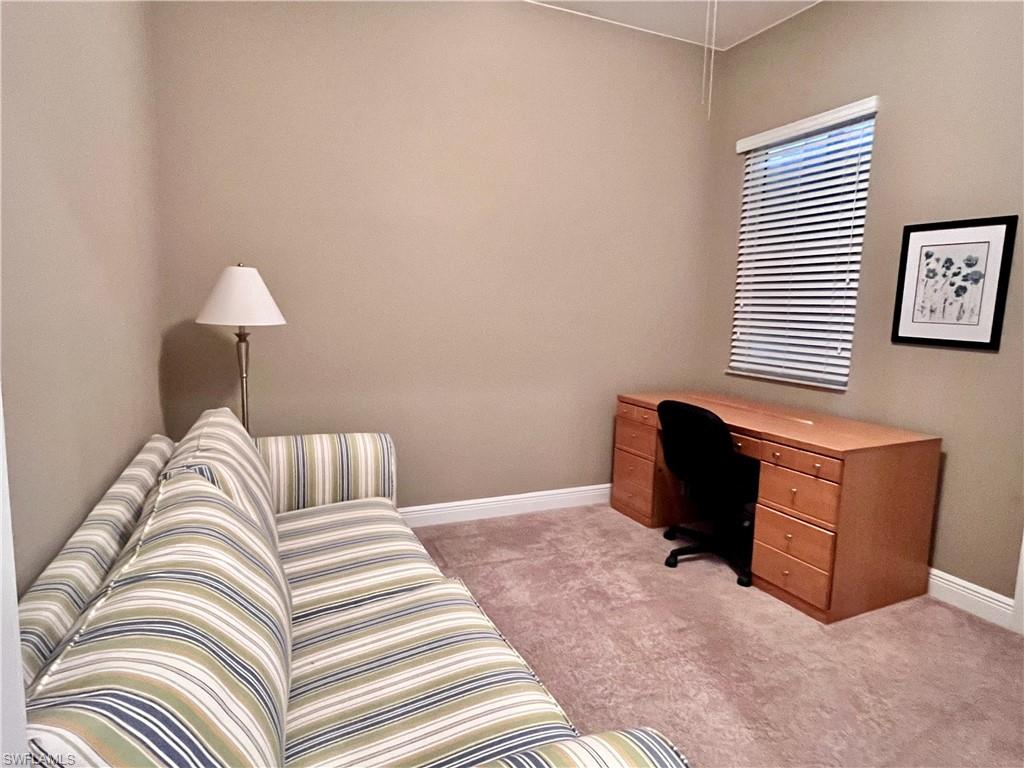 Home office/sitting area featuring desk with a sofa, can be used as an additional bedroom