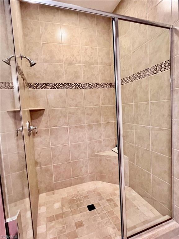 Full bathroom with a shower stall