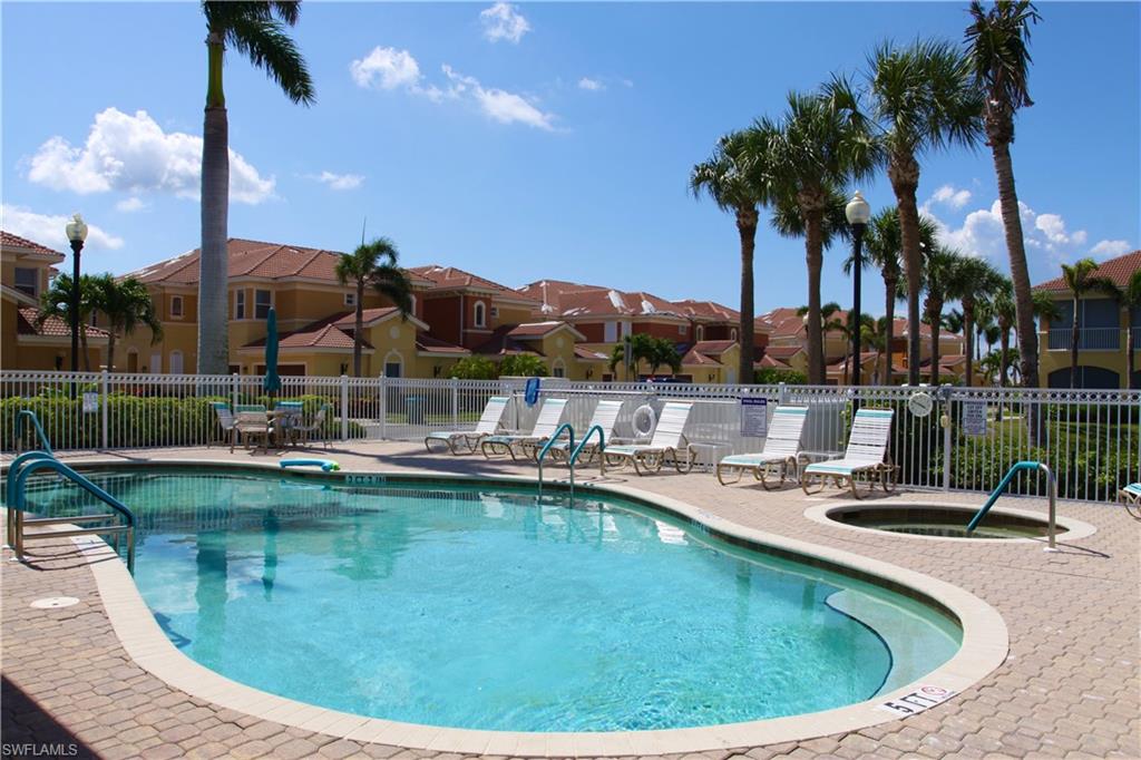 Community pool featuring a residential view, a community hot tub, and a patio area